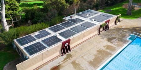 Rooftop installation of commercial solar panels on a building, showcasing an efficient solar system for commercial solar energy generation and solar electricity production.